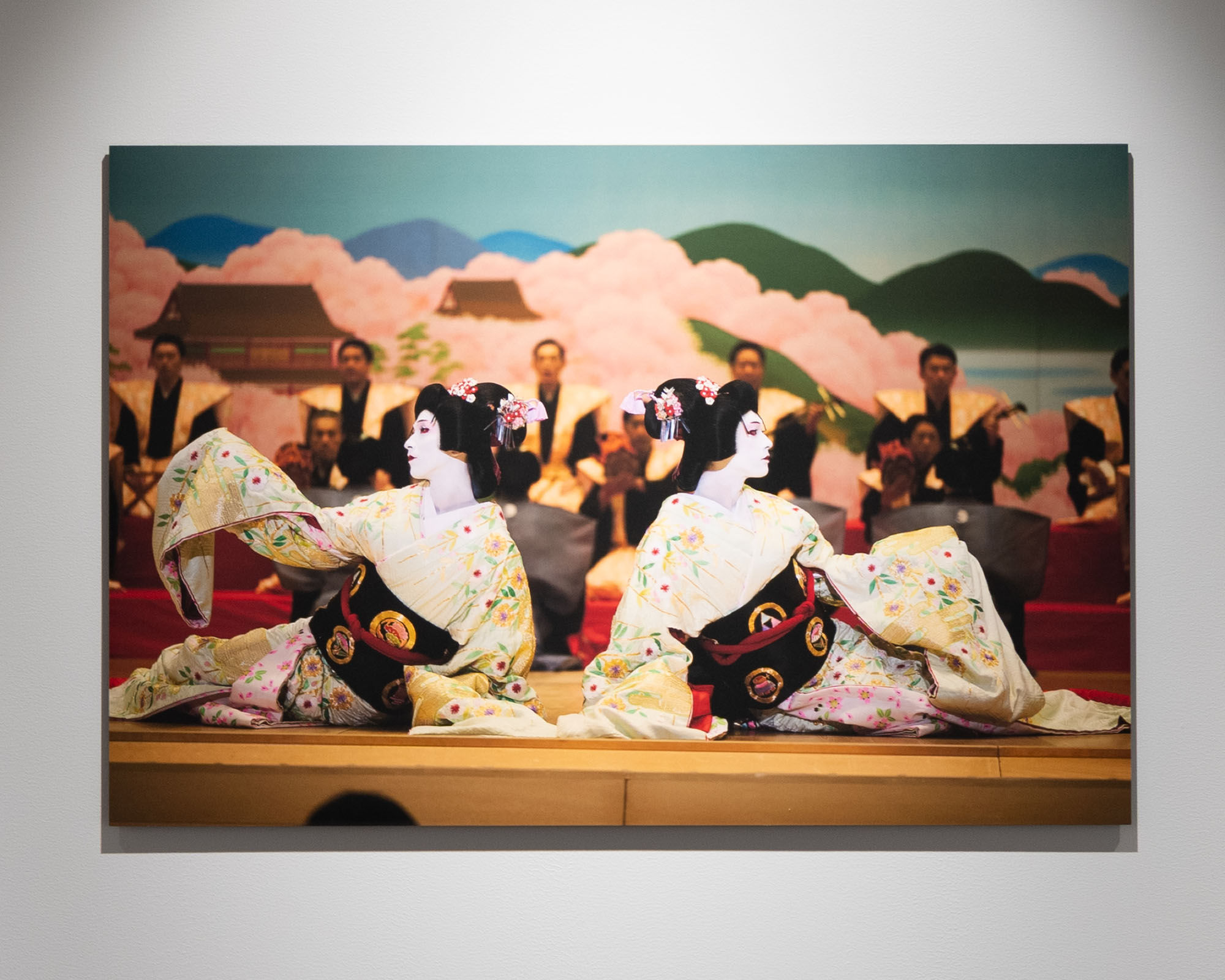 Part of a scene from the Film "KOKUHO." A photographic work capturing a scene on stage, highlighting performers’ movements and costumes, displayed to convey the atmosphere of film and theater.